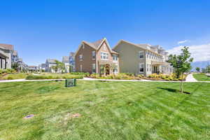 View of front of property with a front yard and stucco siding
