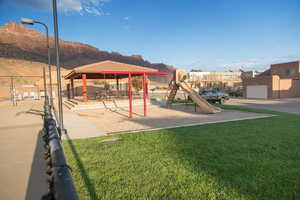 Communal playground with a patio area and a mountain view