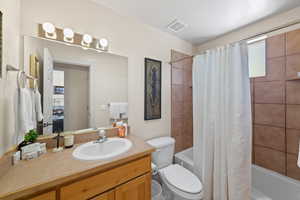 Bathroom featuring shower / tub combo and vanity