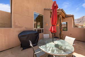 View of patio / terrace with area for grilling, outdoor dining area, and a mountain view