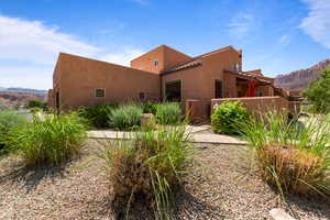 View of front of home featuring a mountain view, stucco siding, and a tiled roof