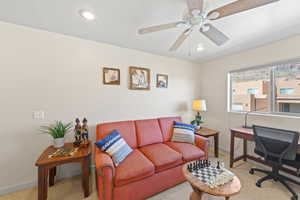 Carpeted office featuring recessed lighting and a ceiling fan