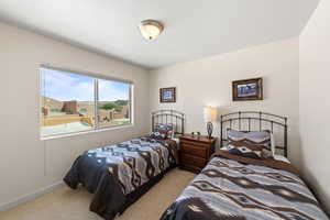 Bedroom featuring light colored carpet and baseboards