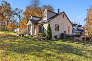 View of property exterior with a yard and a porch