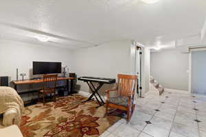 Home office featuring a textured ceiling and light tile patterned floors