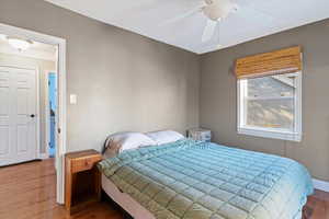 Bedroom with wood finished floors and ceiling fan