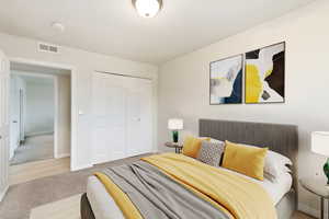 Carpeted bedroom featuring a closet and baseboards