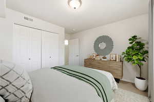 Bedroom featuring a closet and light carpet