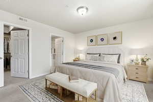 Bedroom featuring light carpet and baseboards