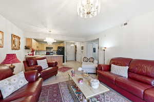 Living area featuring a chandelier and light tile patterned floors