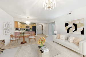 Living area with a chandelier and light tile patterned floors