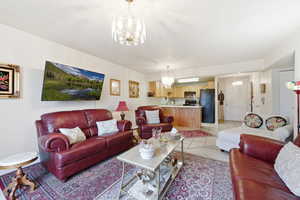 Living area with a chandelier and light wood-style flooring