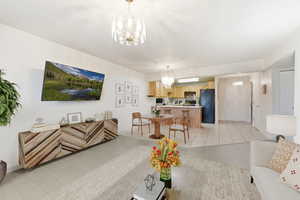 Living room featuring hanging lights and light tile patterned floors