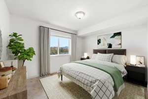 Bedroom featuring light carpet and baseboards