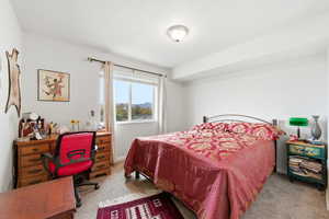 Carpeted bedroom featuring baseboards