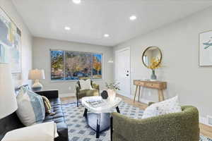 Living area featuring wood finished floors and recessed lighting