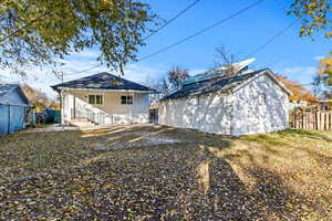 Back of house with an outbuilding