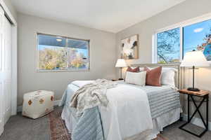 Carpeted bedroom with a closet and baseboards
