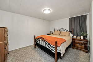 Carpeted bedroom with baseboards