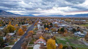 Aerial perspective of suburban area with mountains and property parcel outlined