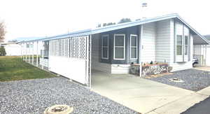 View of side of home featuring a yard