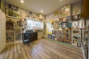 Home office with light wood-style flooring and recessed lighting