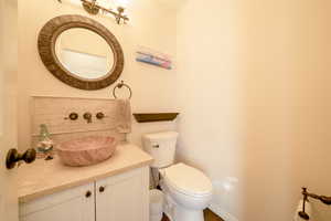 Bathroom with vanity and backsplash