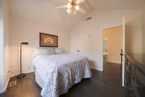 Bedroom featuring dark wood flooring, high vaulted ceiling, a ceiling fan, a closet, and beam ceiling