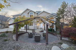 View of front of property with a patio and stucco siding