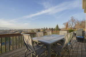 Deck with outdoor dining space and a mountain view