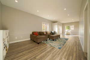 Living room with recessed lighting and light wood-style flooring