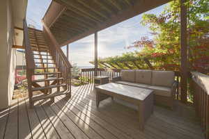 Wooden terrace with stairs and an outdoor hangout area