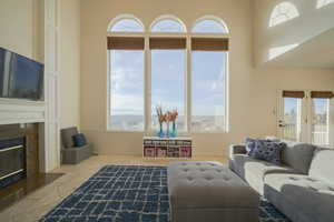 Living area featuring a fireplace, healthy amount of natural light, and tile patterned floors