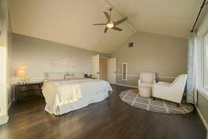 Bedroom featuring beam ceiling, high vaulted ceiling, dark wood flooring, and ceiling fan