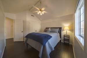 Bedroom featuring beam ceiling, dark wood floors, a closet, a ceiling fan, and high vaulted ceiling