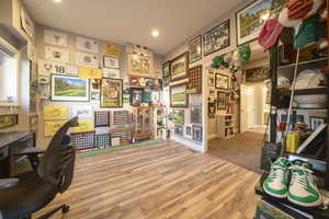 Home office with wood finished floors and recessed lighting