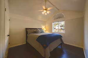 Bedroom featuring dark wood flooring and ceiling fan