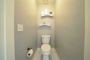 Bathroom featuring baseboards and marble finish flooring