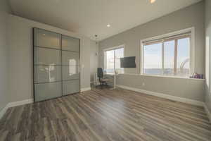Unfurnished office with wood finished floors and recessed lighting