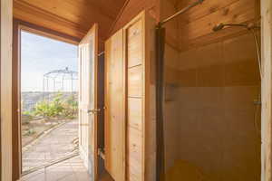 Bathroom featuring a shower stall and tile patterned floors
