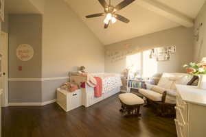 Bedroom featuring dark wood floors, ceiling fan, and high vaulted ceiling