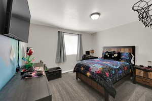 Bedroom with carpet flooring and baseboards