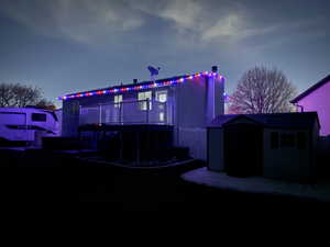 View of front of property with a shed, a chimney, and a wooden deck