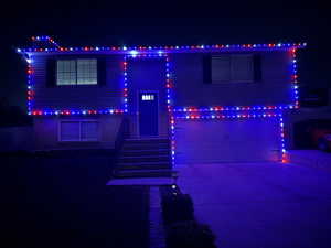 View of front of home with driveway and an attached garage