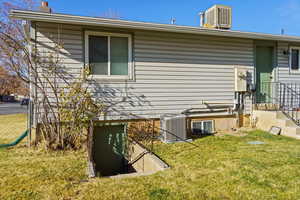 View of home's exterior with a chimney and a yard