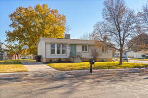 View of front of home featuring a front yard and driveway