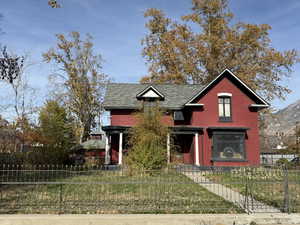 View of front of house with a fenced front yard and brick siding