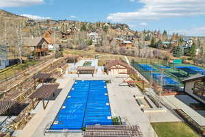 Community pool with a residential view, a patio, and a mountain view