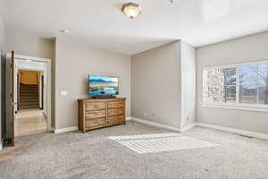Bedroom featuring light colored carpet and baseboards