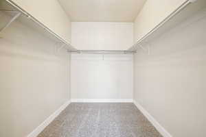 Walk in closet with light carpet